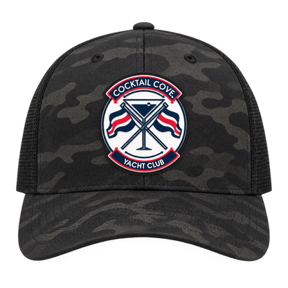 Black camo Cocktail Cove Yacht Club trucker hat, front view of the badge patch