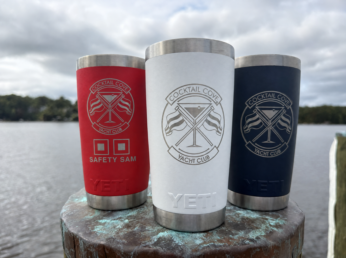 Special Edition 20oz Yeti set of 3 on a dock piling: red Safety Sam, white, and navy Ramblers engraved with the Cocktail Cove Yacht Club crest