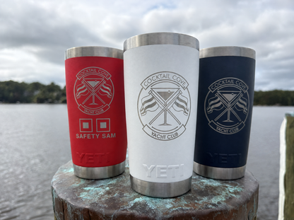 Special Edition 20oz Yeti set of 3 on a dock piling: red Safety Sam, white, and navy Ramblers engraved with the Cocktail Cove Yacht Club crest